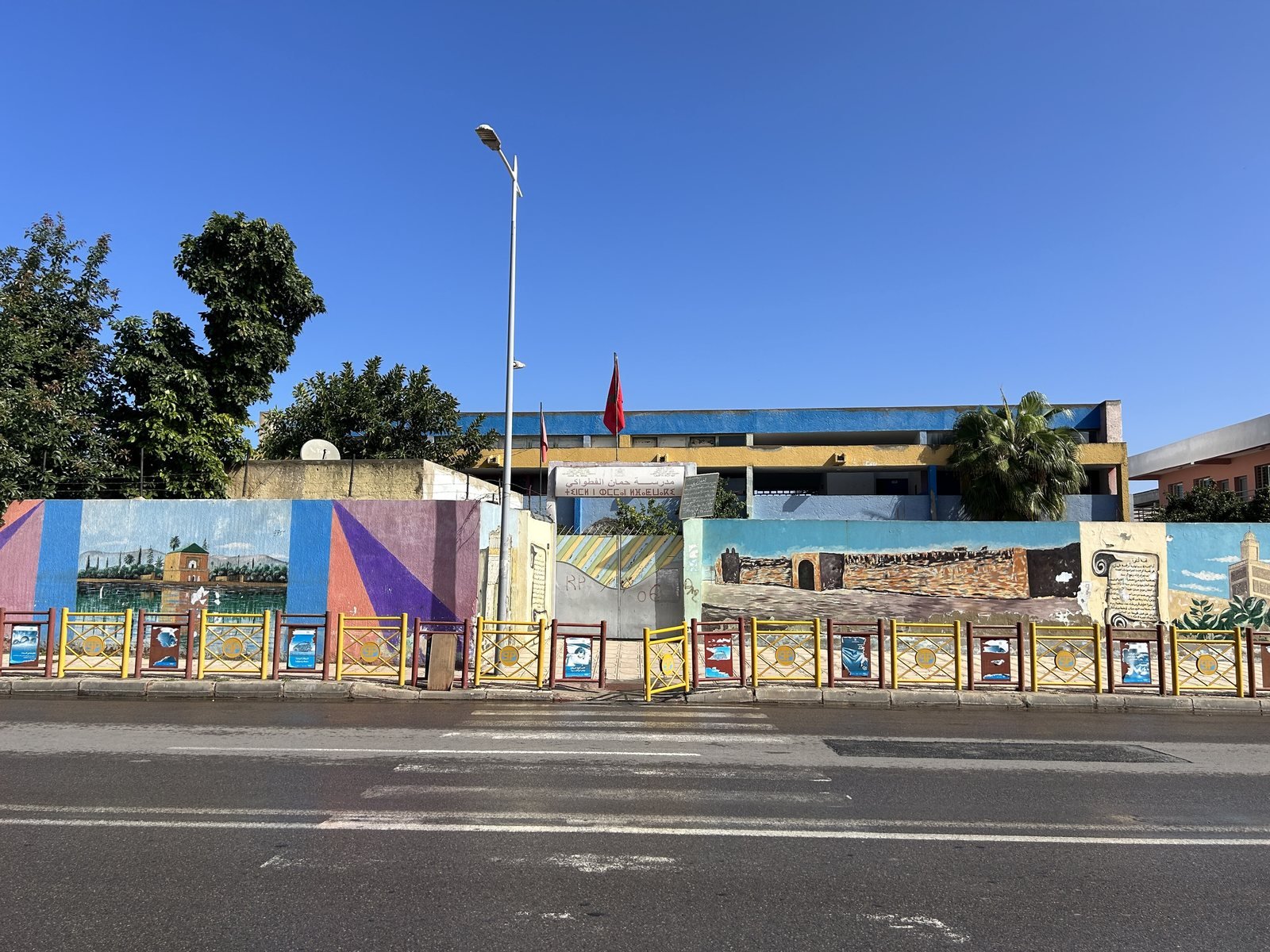 Façade d'une école à Salé, avec un mur d'enceinte décoré de fresques colorées